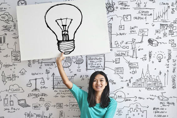 woman holding up light bulb